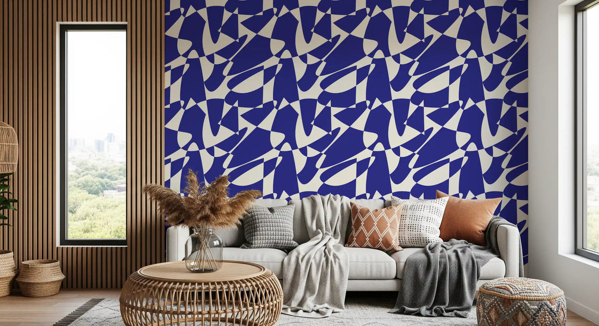 Blue and cream geometric wallpaper behind a grey sofa against a wooden slat wall GD12480