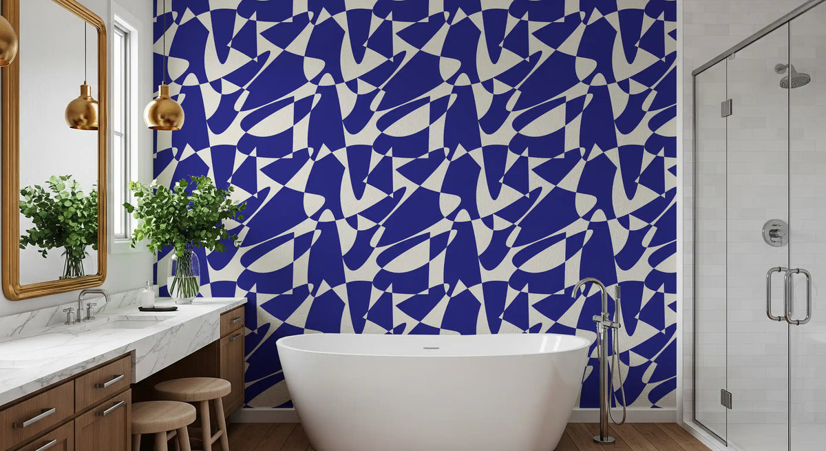 Cobalt blue geometric wallpaper in a bathroom with a freestanding tub and marble vanity GD12480