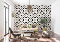Black and white star grid wallpaper in a boho room with a lounge chair and terracotta floor GD12482