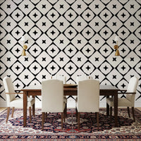 Monochrome star grid wallpaper in a dining room with white chairs and a patterned rug GD12482