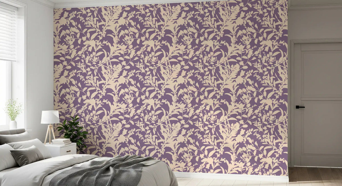 Purple botanical silhouette wallpaper behind a grey bed with a soft throw GD12484