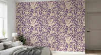 Purple botanical silhouette wallpaper behind a grey bed with a soft throw GD12484