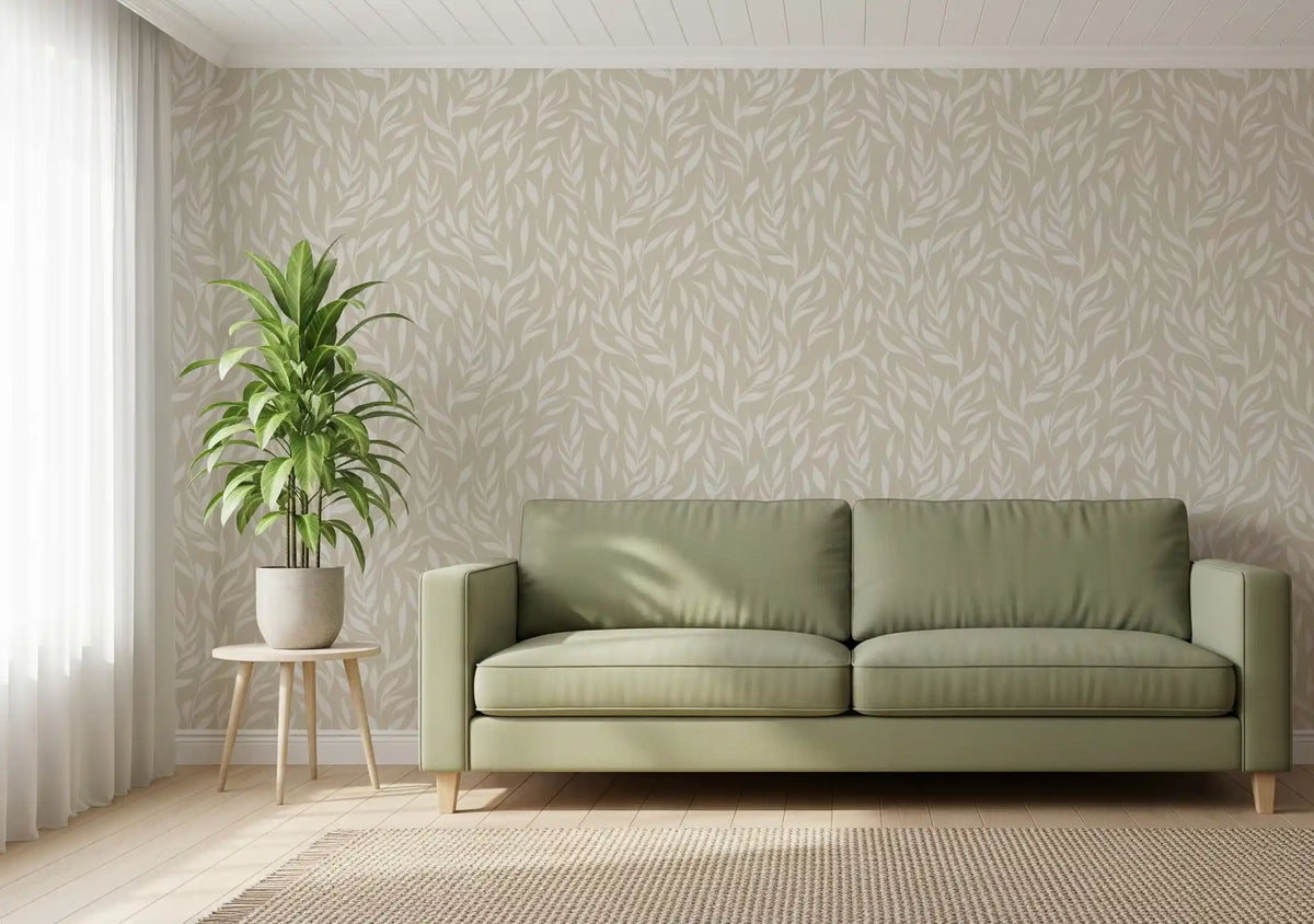 Cream botanical leaves wallpaper behind a sage green sofa and potted palm GD12486