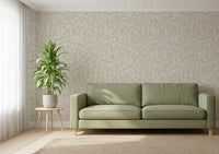 Cream botanical leaves wallpaper behind a sage green sofa and potted palm GD12486