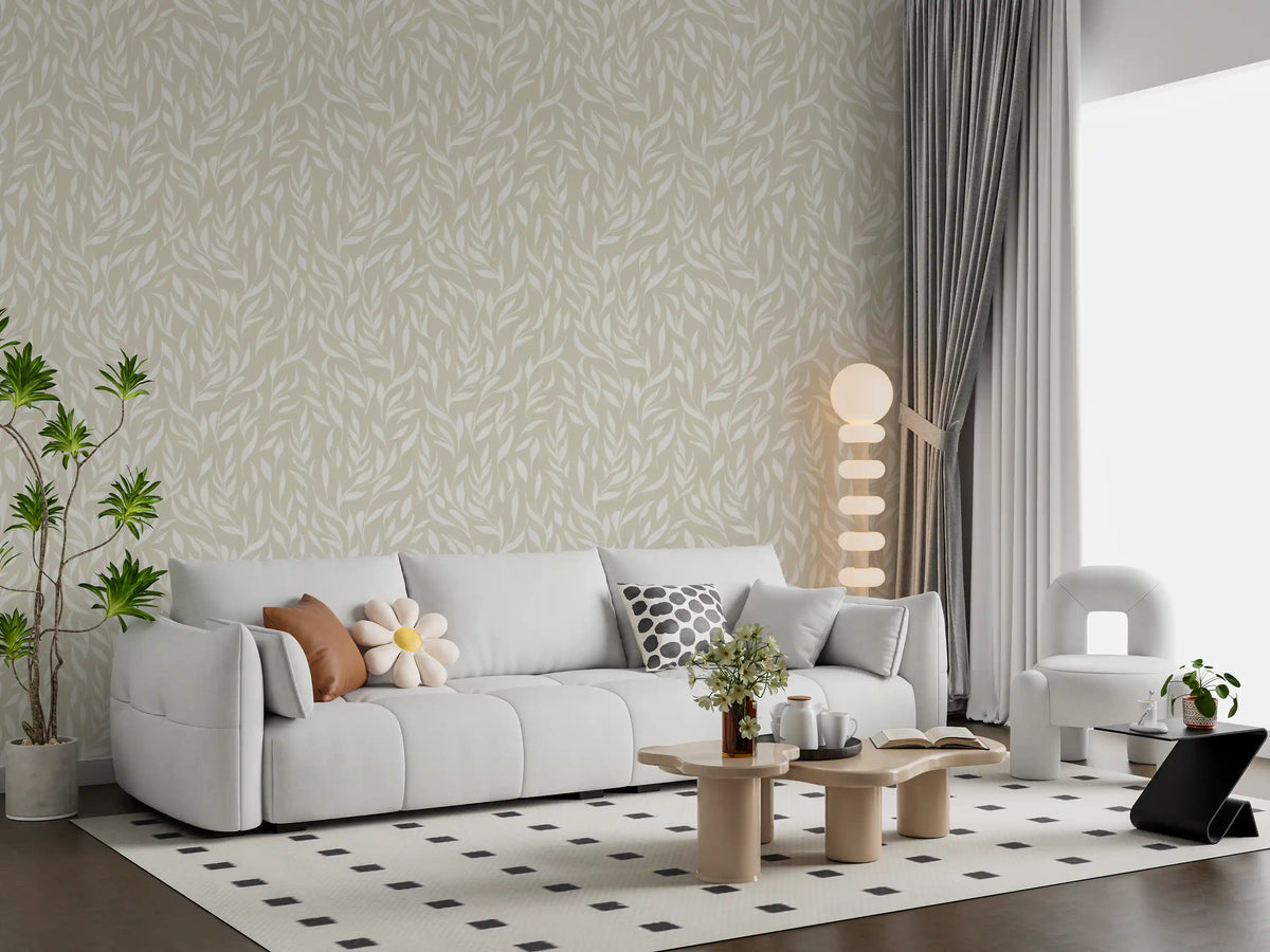 Serene cream botanical leaves wallpaper behind a light grey sofa GD12486