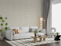 Serene cream botanical leaves wallpaper behind a light grey sofa GD12486