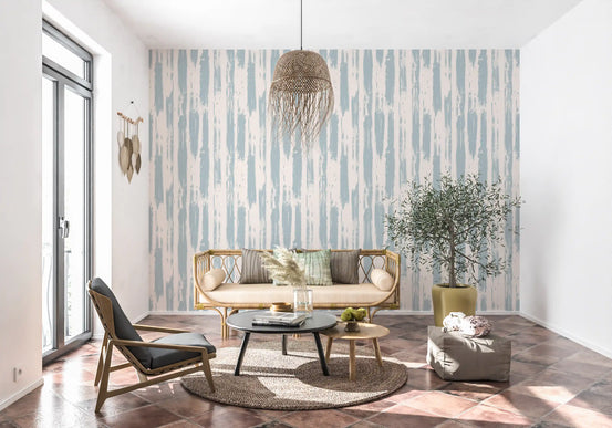 Nordic painted stripe wallpaper behind a cane loveseat and black leather chair GD12490