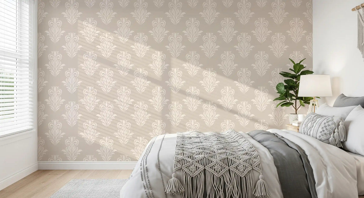 Cosy bedroom with grey bedding and a knit throw on cream damask scroll wallpaper GD12492
