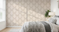 Cosy bedroom with grey bedding and a knit throw on cream damask scroll wallpaper GD12492