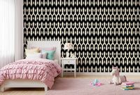 Girls bedroom with pink ruffled bedding on abstract interlocking diamond wallpaper GD12494