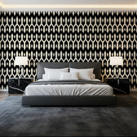 Dark grey bed and twin lamps framed by abstract interlocking diamond motif wallpaper GD12494