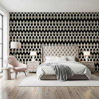 Black and cream diamond motif wallpaper in a bedroom with a pink accent chair GD12494