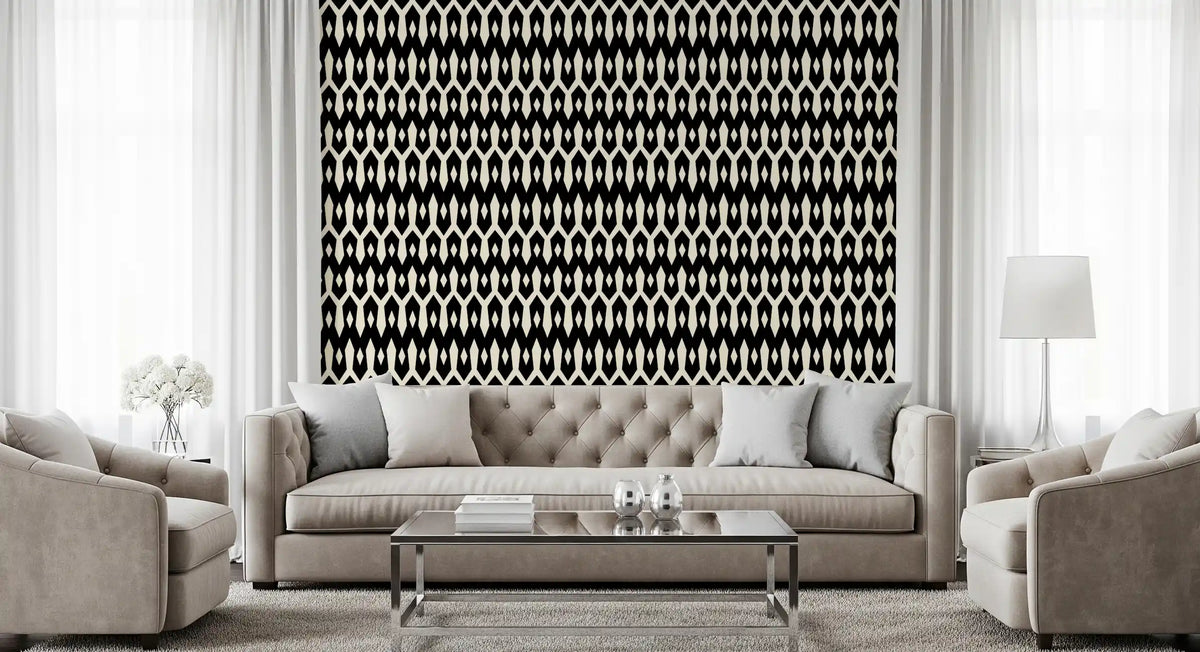 Abstract interlocking diamond motif wallpaper behind a tufted grey sofa and glass table GD12494