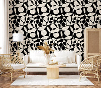 Interlocking circles wallpaper behind a white sofa with rattan chairs and pampas GD12497
