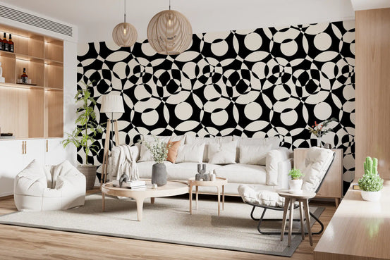 Monochrome circles wallpaper behind a beige sofa in a wood-shelved living room GD12497
