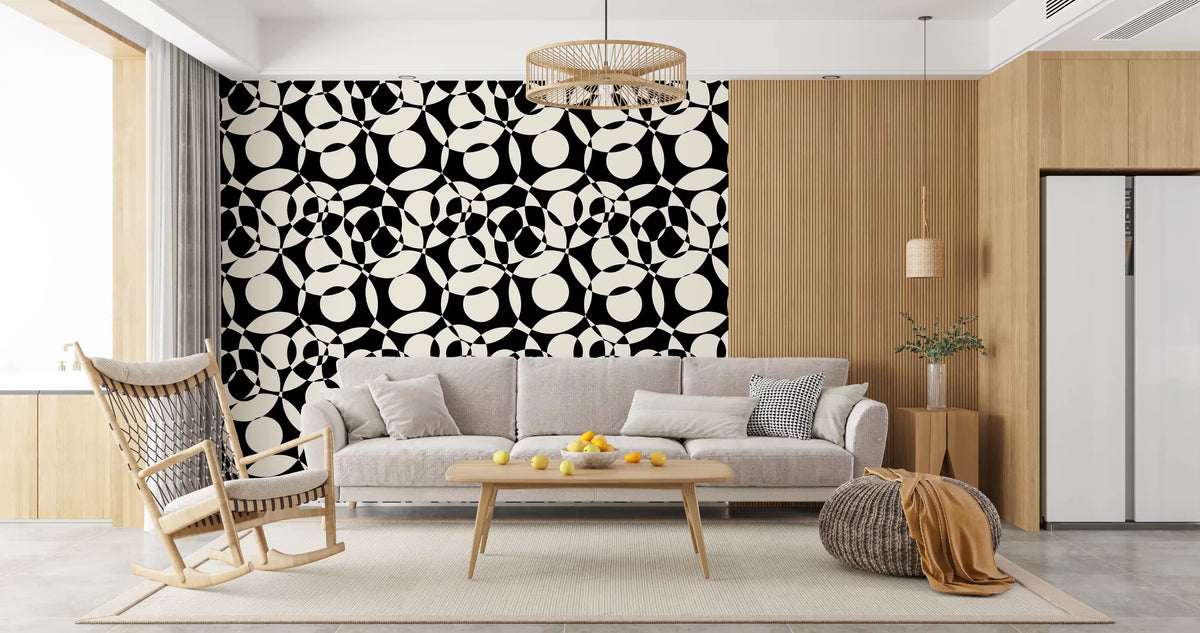 Black and white circles wallpaper behind a grey sofa near an open kitchen GD12497