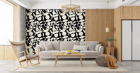Black and white circles wallpaper behind a grey sofa near an open kitchen GD12497