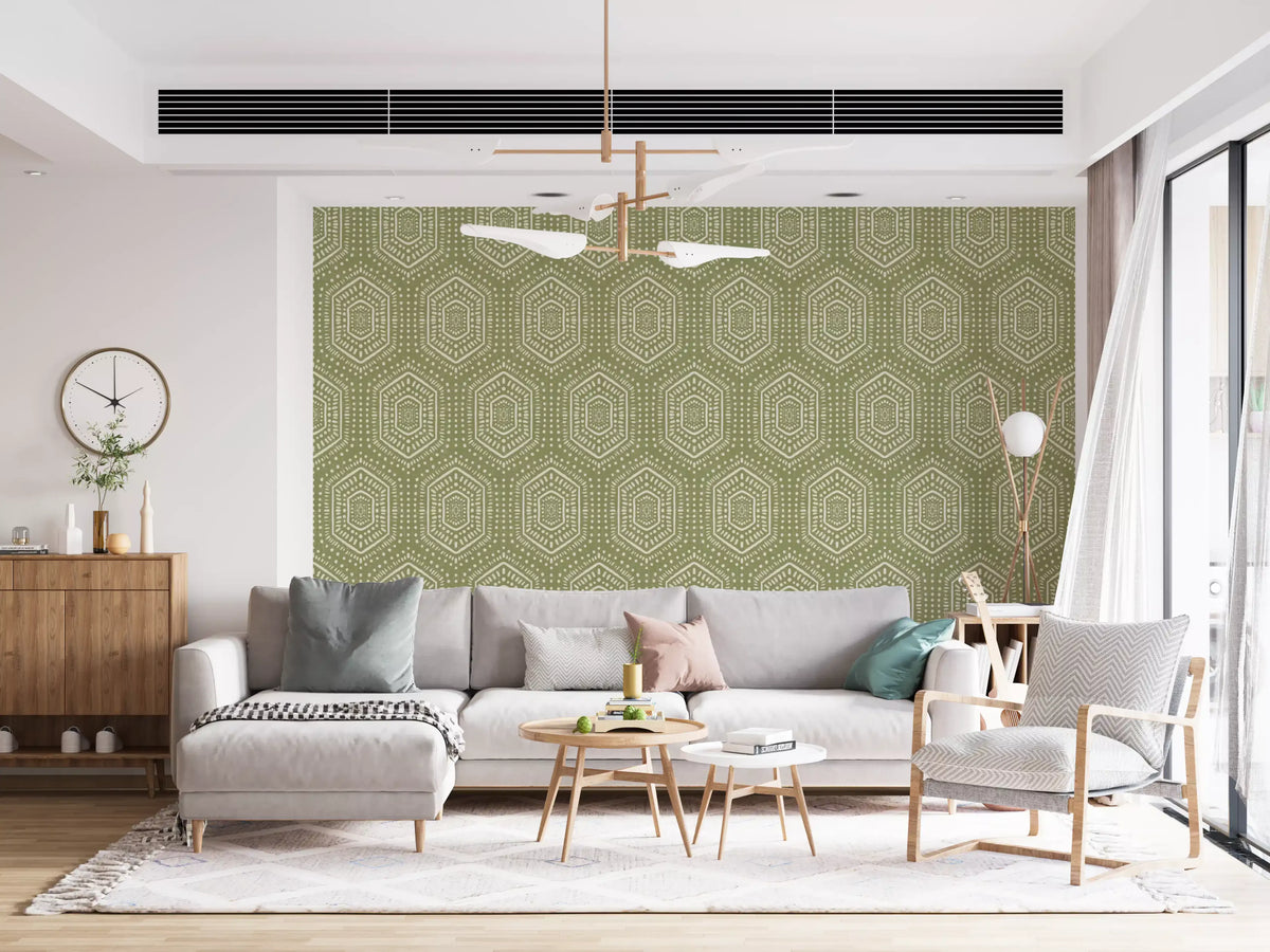 Meadow green boho hexagon wallpaper behind a grey sofa and wood sideboard in a bright living room GD12657