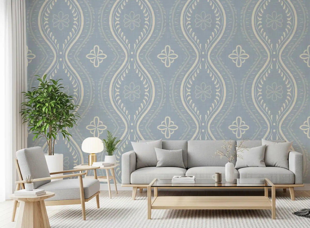 French country blue damask wallpaper behind a grey sofa and potted plant in a bright living room GD12663