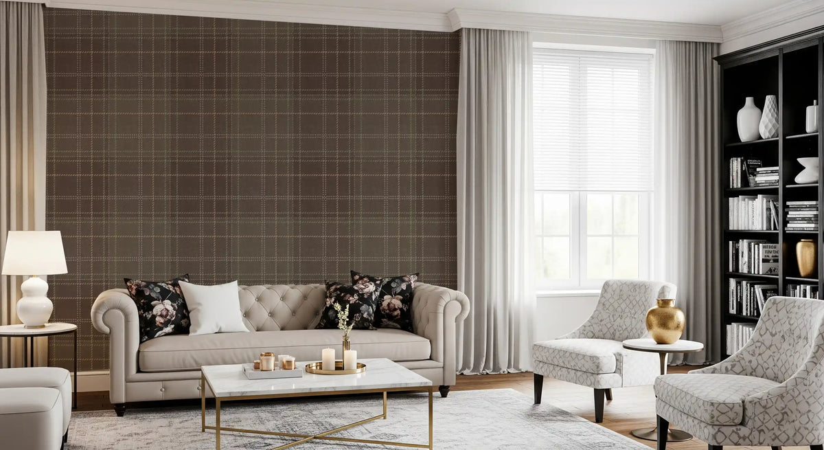 Tartan plaid wallpaper behind a beige tufted sofa with floral cushions GD12727