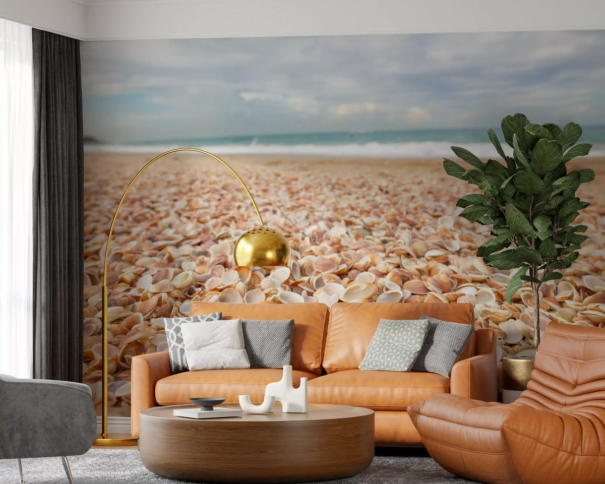 Seashell beach wall mural behind a tan leather sofa and arc floor lamp GD12799