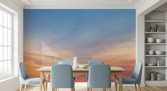 Amber dusk sky wall mural behind a dining table with soft blue chairs GD12809
