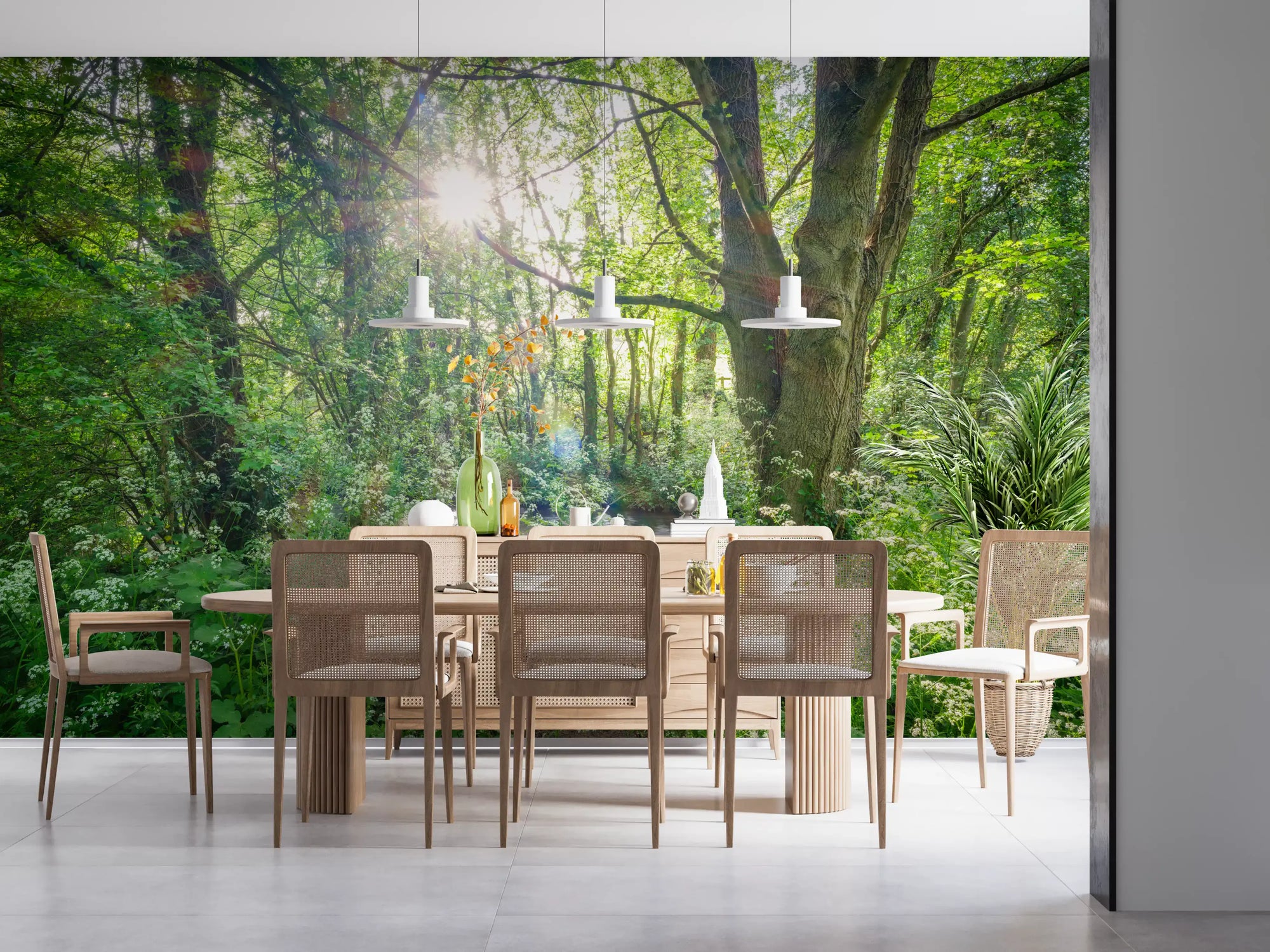 Woodland stream wall mural behind a wooden dining table with woven chairs GD12810