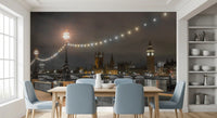 Warm string lights arc over the Thames wall mural above a dark river GD12841

