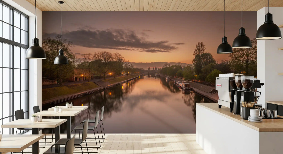 Sunset canal wall mural behind a bright cafe bar with coffee machines and window tables GD12847