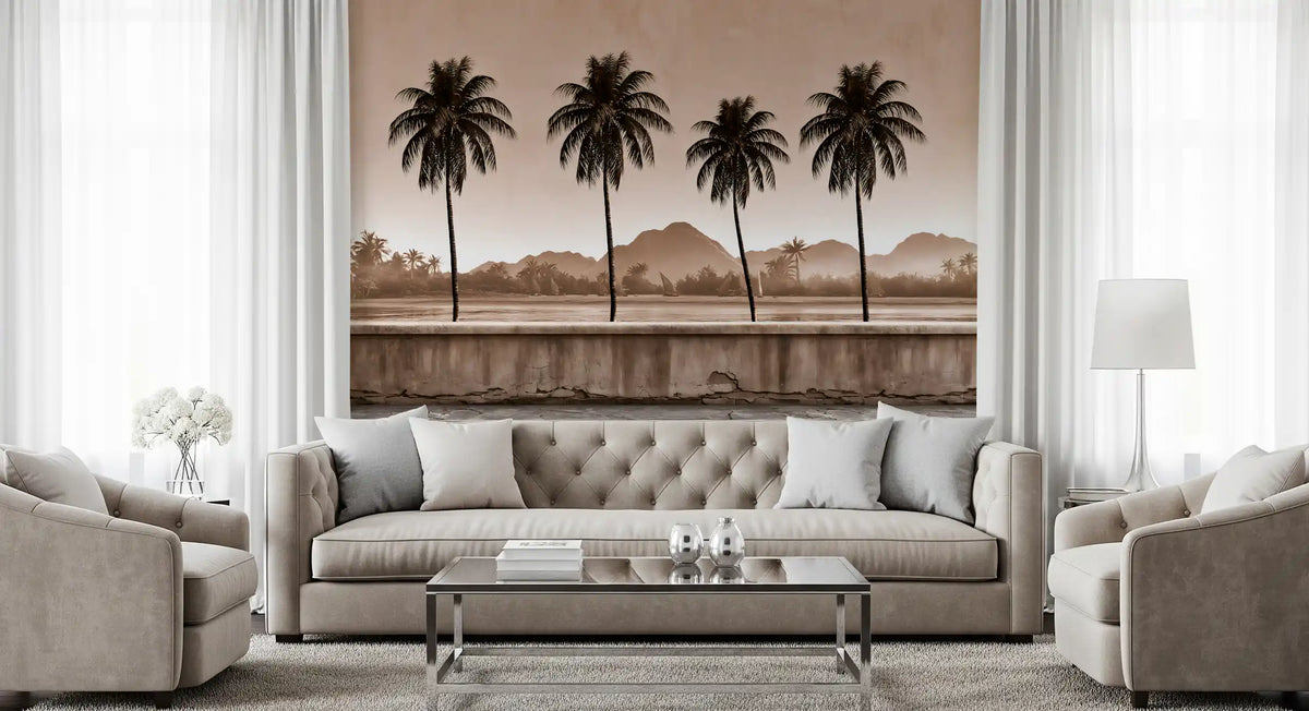 Sepia palm shoreline mural behind a grey tufted sofa and glass coffee table GD12915