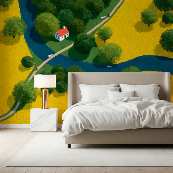 Countryside meadow wall mural behind a beige upholstered bed with a gold bedside lamp GD12955