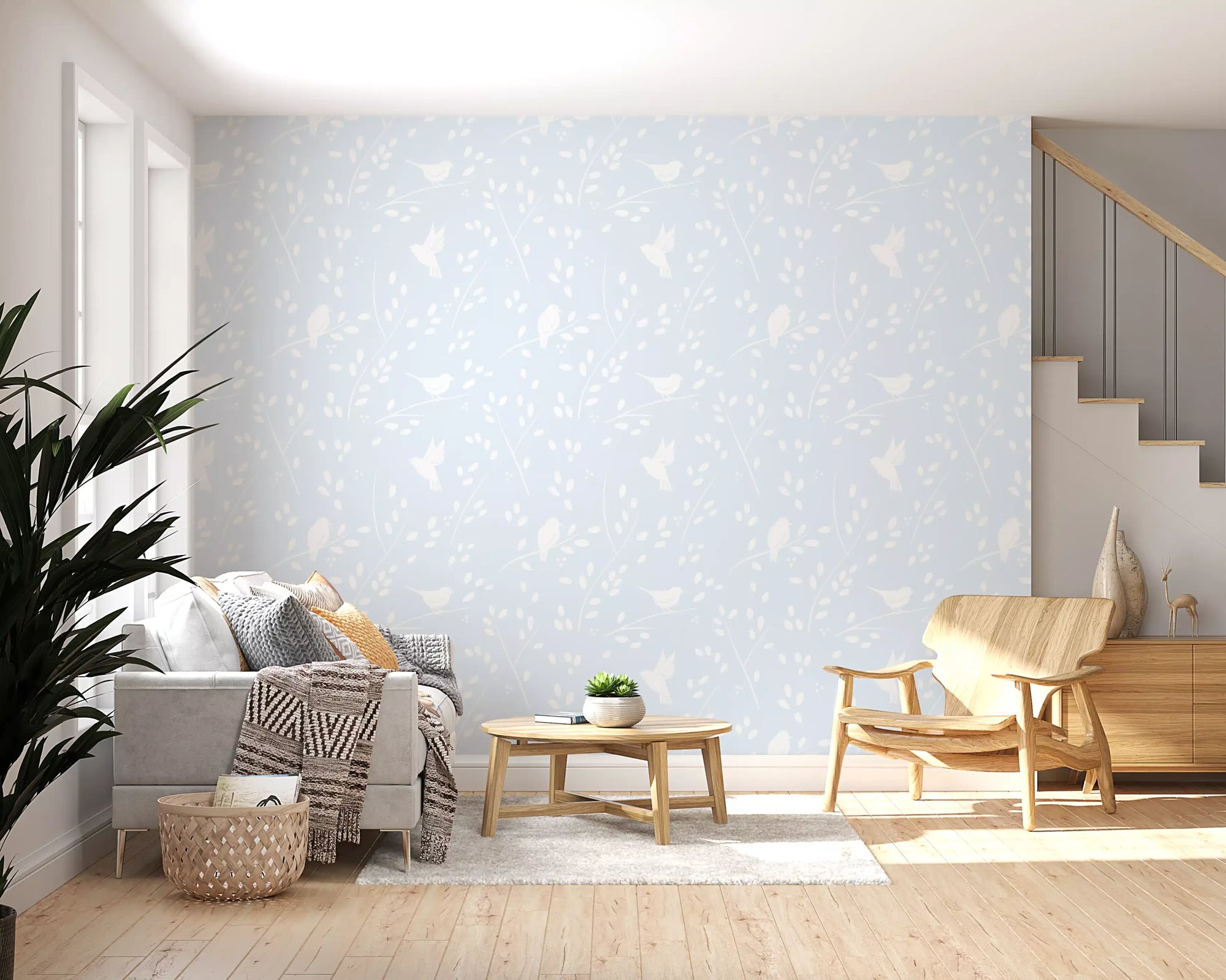 Pastel blue winter birds wallpaper in a living room with a grey sofa and staircase GD12980