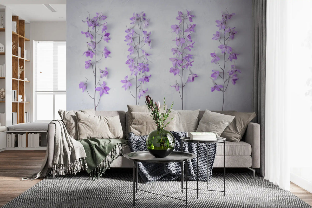 Lilac delphinium wallpaper behind a gray sofa with black side tables and a bookshelf GD13138
