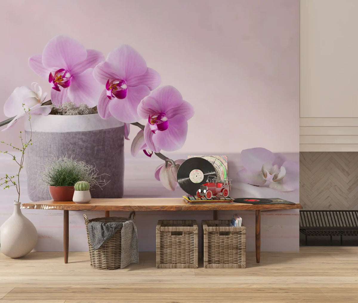 Floral wallpaper above a wooden console with a record player and woven storage baskets GD13139