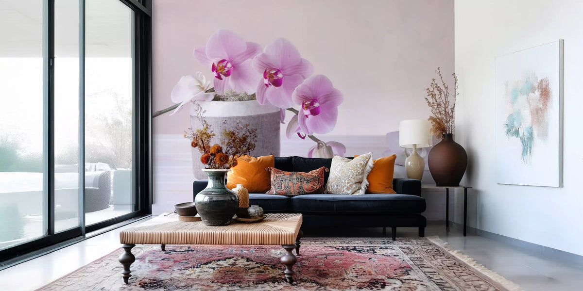 Floral wallpaper behind a navy sofa with orange cushions and a patterned rug GD13139