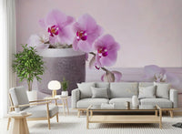 Pink orchid mural in a bright living room with a gray sofa and light wood coffee table GD13139