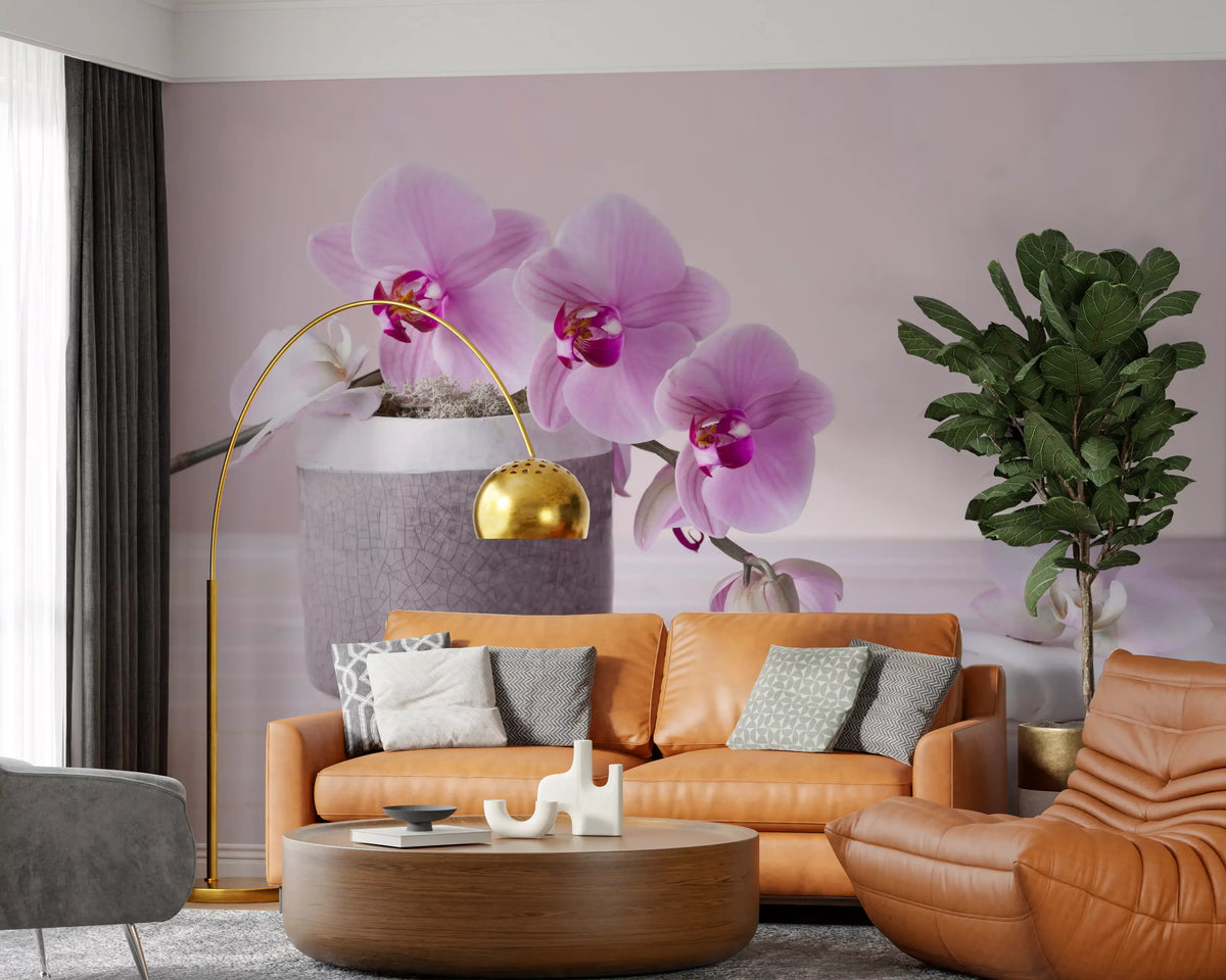 Pink orchid wall mural behind a tan leather sofa with a gold arc lamp and round table GD13139