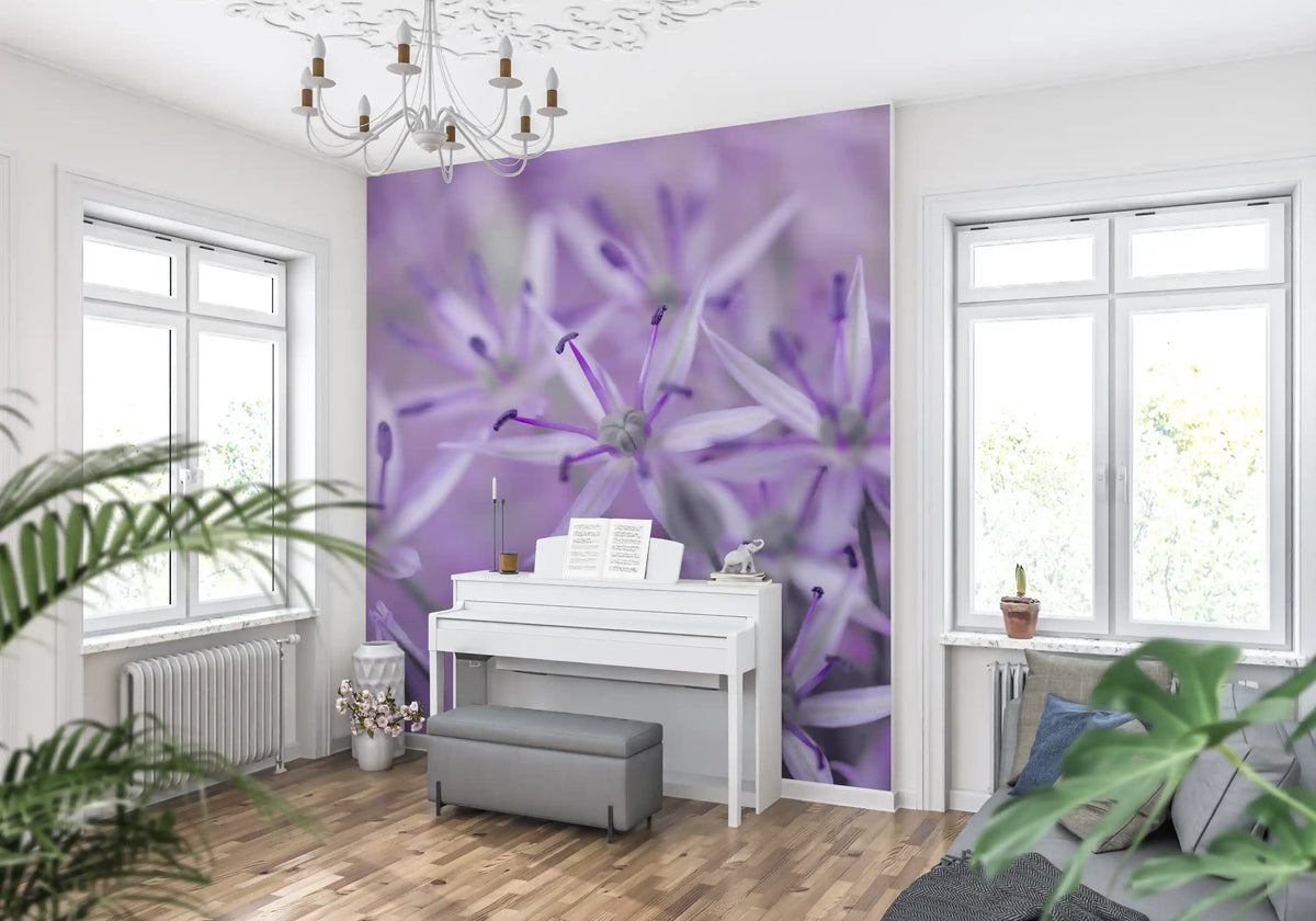 Purple floral wallpaper behind a white upright piano under a chandelier GD13140