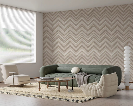 Zigzag wallpaper behind a sage green curved sofa, boucle armchair and round wooden coffee table GD13705