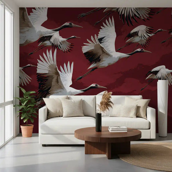 Crimson bird wallpaper with flying cranes behind a white sofa and round walnut coffee table GD13815