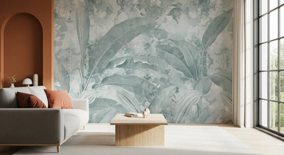 Tropical wallpaper mural of aqua banana leaves behind gray sofa and terracotta arch GD13966