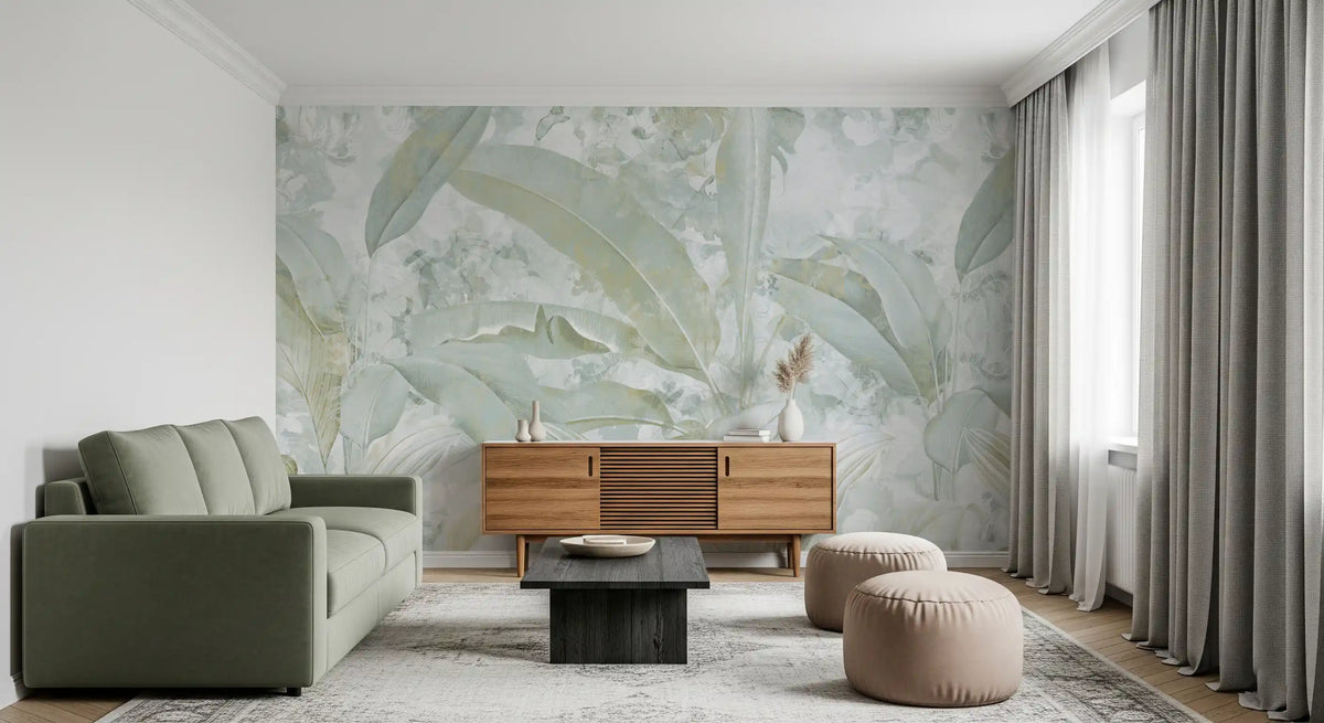Sage green sofa, wooden sideboard and round poufs on a sage banana leaf mural GD13976