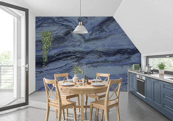 Marble wallpaper in a kitchen with a round wood dining set, blue cabinets and a white pendant GD13993