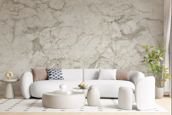 Curved white boucle sofa and round ottoman before cream marble wallpaper mural GD14012