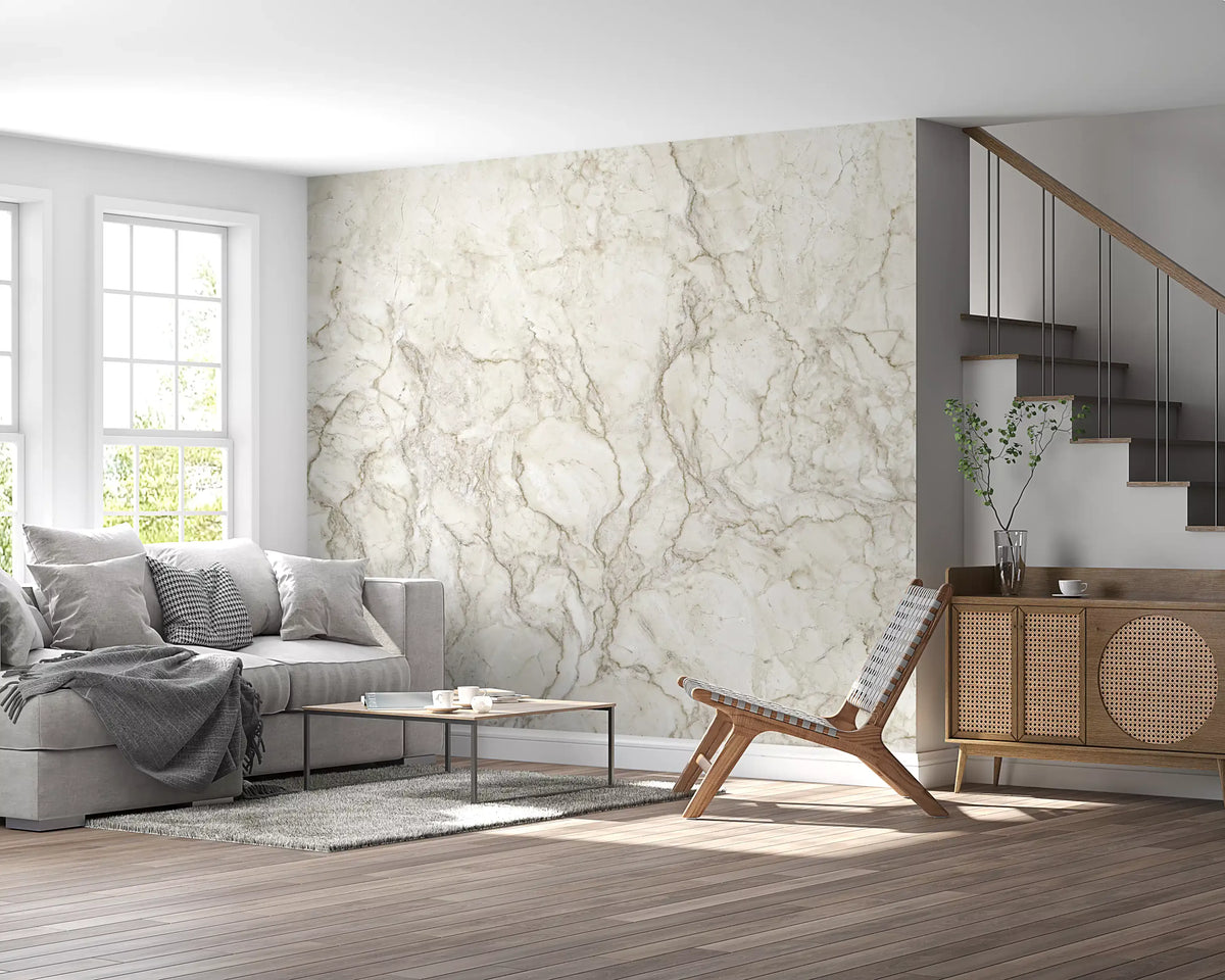 Marble wallpaper in cream behind a gray sofa next to a staircase and rattan sideboard GD14018