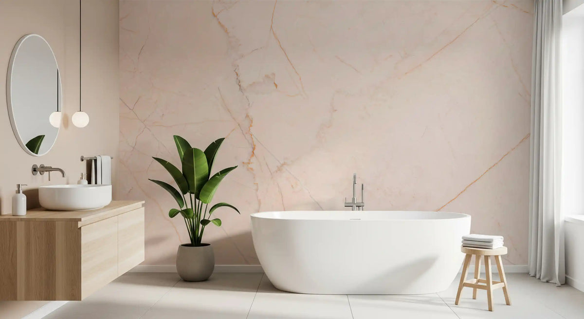 Marble wallpaper mural in blush peach behind a white freestanding tub and oak vanity GD14026