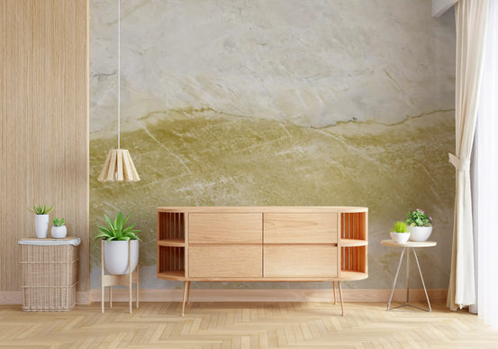Marble wallpaper mural with an ochre gold band behind a wooden sideboard and potted plants GD14050