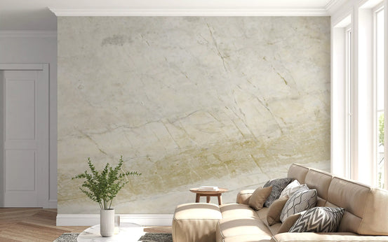 Tan leather sofa with patterned cushions against a cream honed marble wallpaper mural GD14052