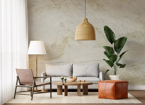 Marble wallpaper mural with gold swirls behind a gray loveseat and tan leather pouf GD14053