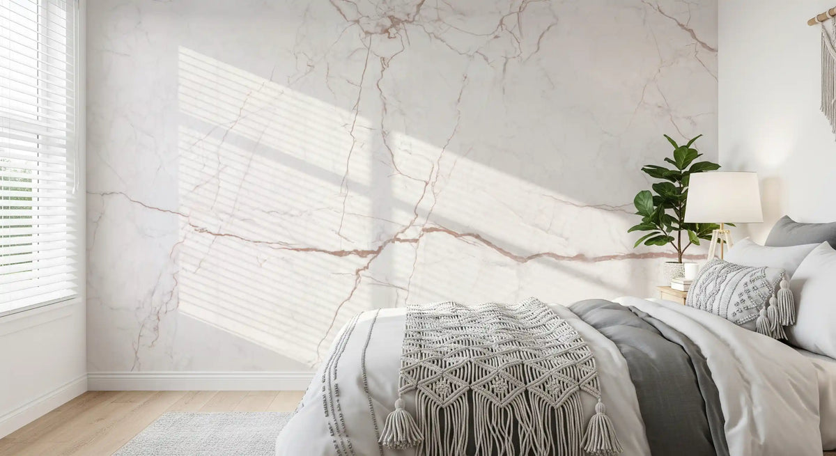Bedroom corner with macrame throw and slatted sunlight on blush veined marble wall GD14071
